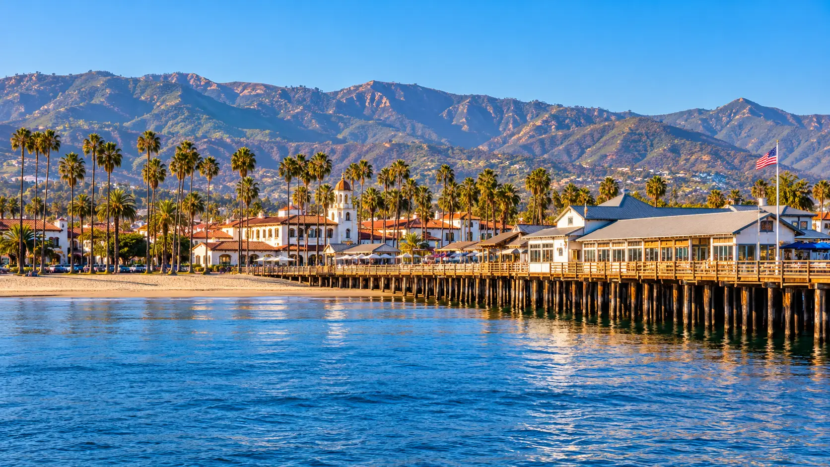 Santa Barbara waterfront and Stearns Wharf with palm trees and coastal mountains, a destination served by Modern Limousine Service